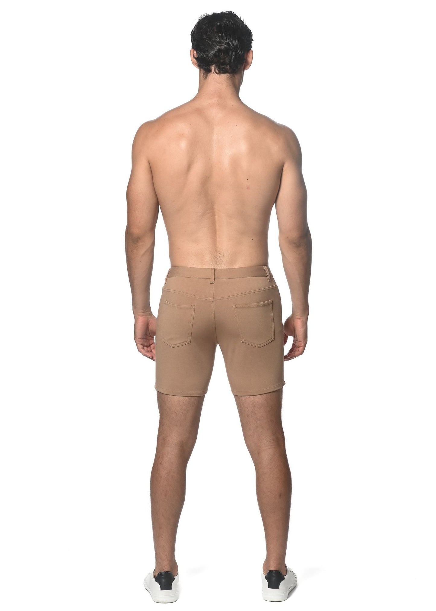 Beige stretch knit shorts with tailored fit and two rear pockets shown from the back side