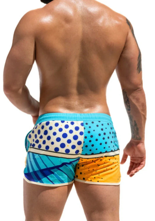 Super dog swim short vibrant patchwork swim trunks in turquoise white with blue polka dots and yellow orange hues