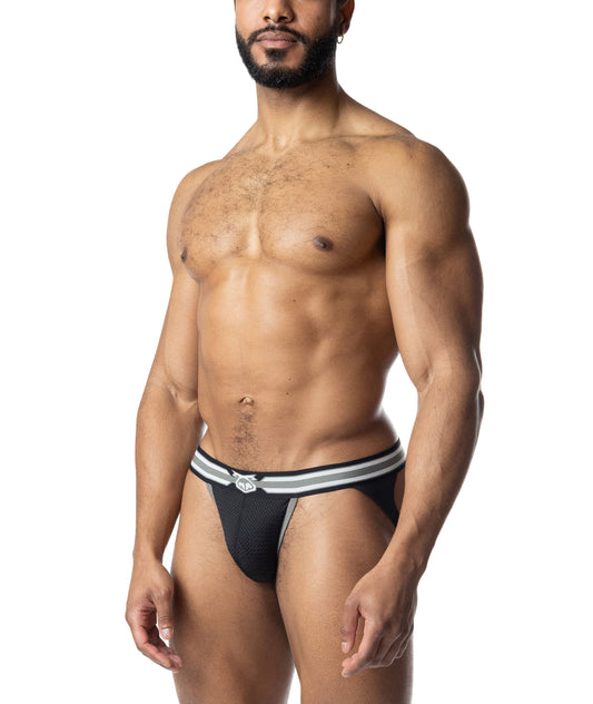 A person wearing a black mesh jockstrap with a white-striped waistband and a small logo on the front.