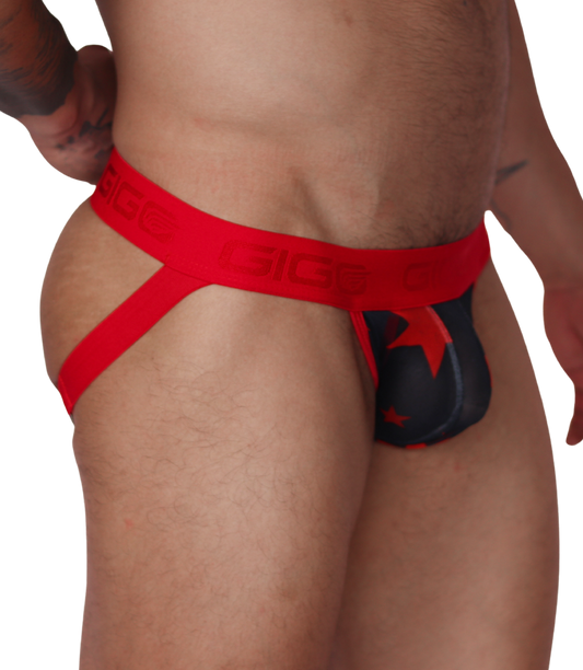 Side view of a Gigo red and black star-print jockstrap with branded elastic waistband and soft fabric pouch.