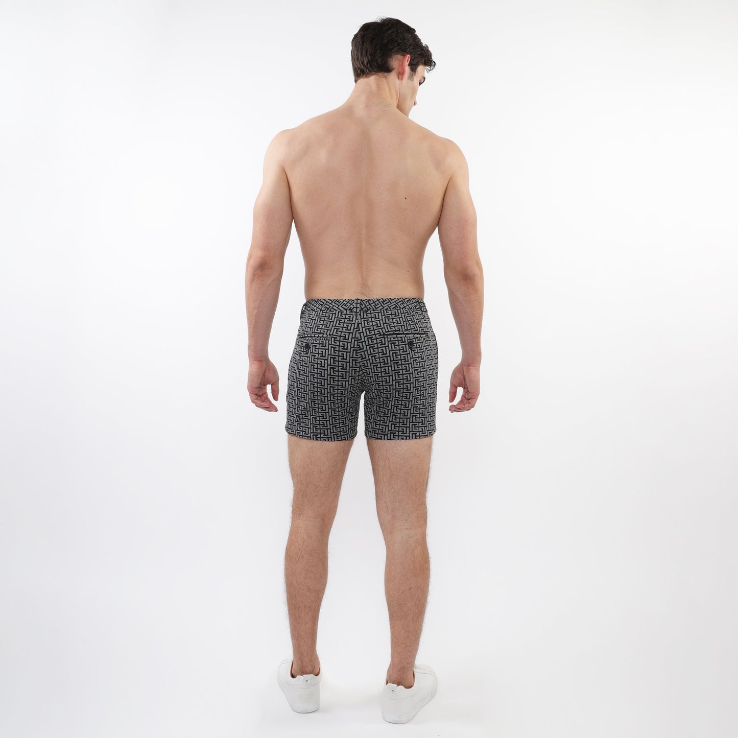 Black and white geometric patterned textured jacquard stretch knit chino swim trunks with zip pockets