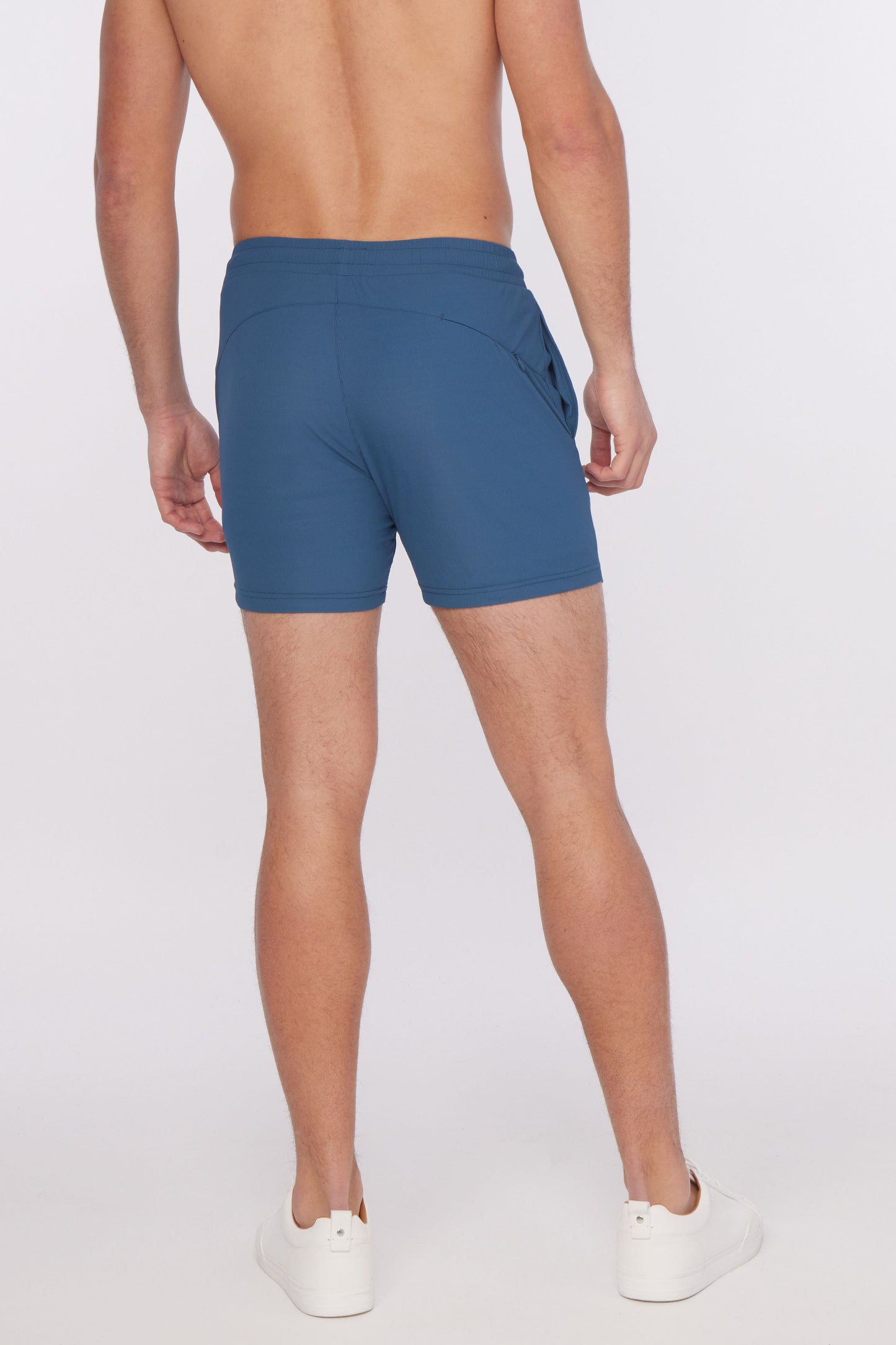 Blue textured stretch performance shorts with a sleek form-fitting design and subtle side pockets for athletic use