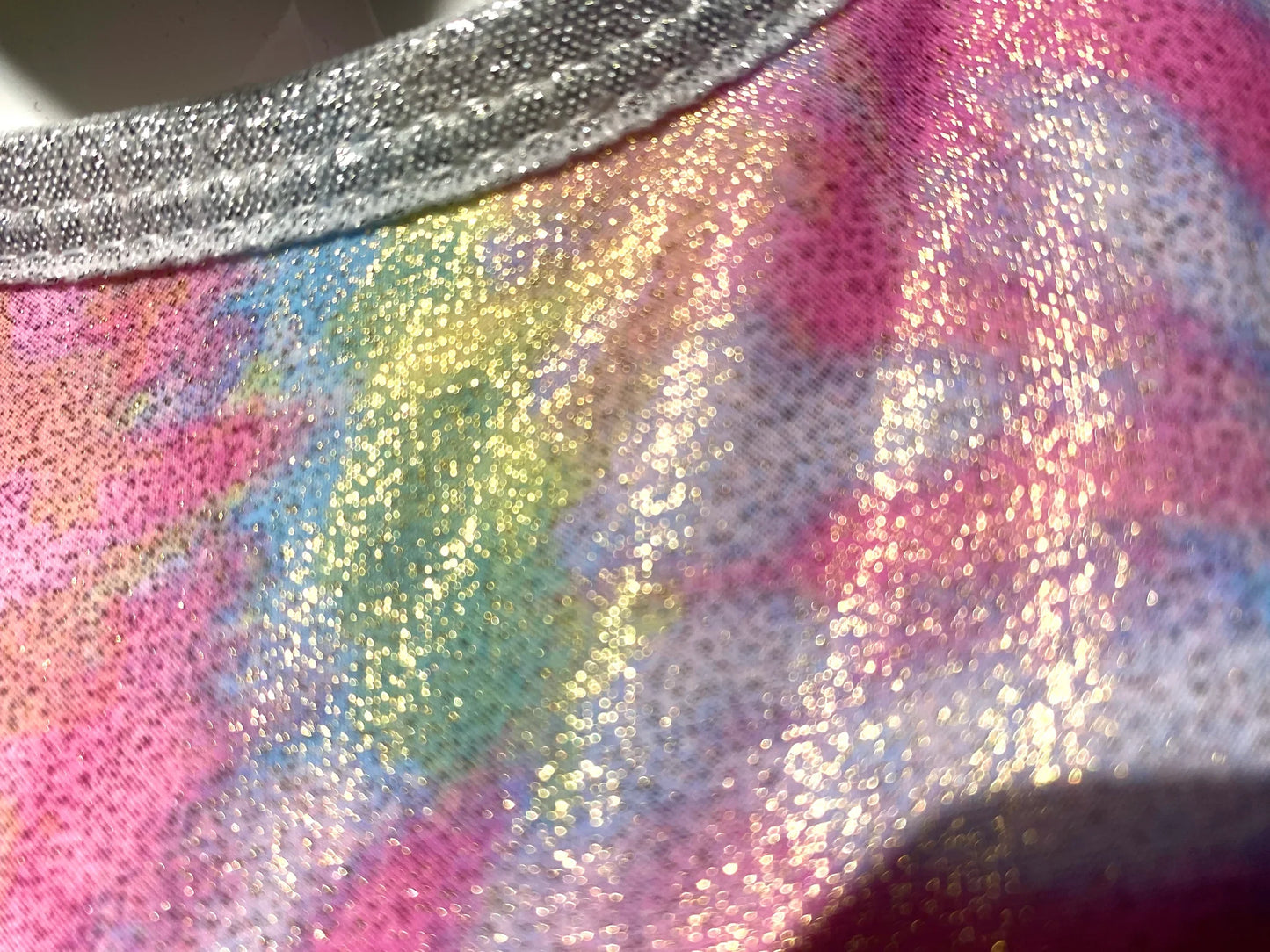 Tie dye crop top shimmering iridescent tank with rainbow gradient and silver glitter trim in front view