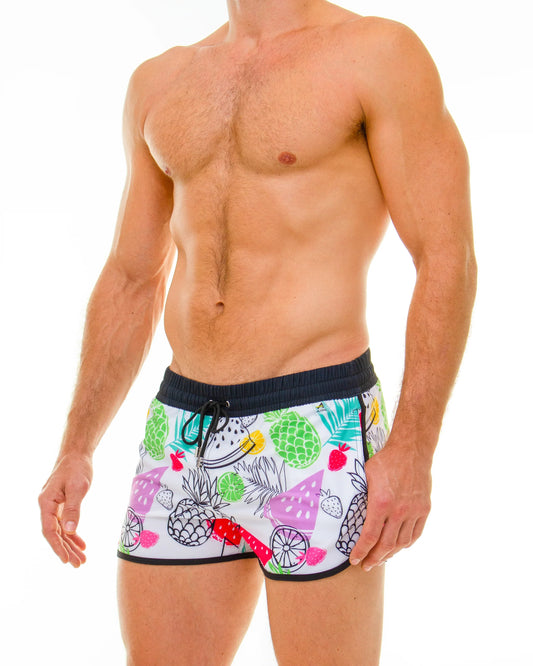 White tropical fruit swim shorts featuring colorful pineapples watermelon and strawberries pattern for beachwear