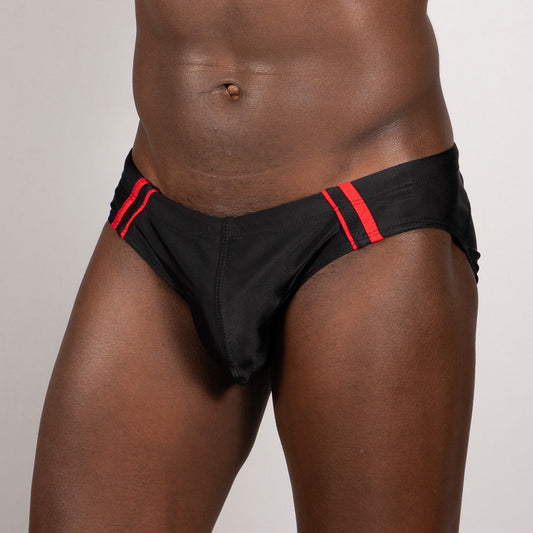 Black tulio brief swim trunks with bold red pipping stripe along the waistband for a sporty look