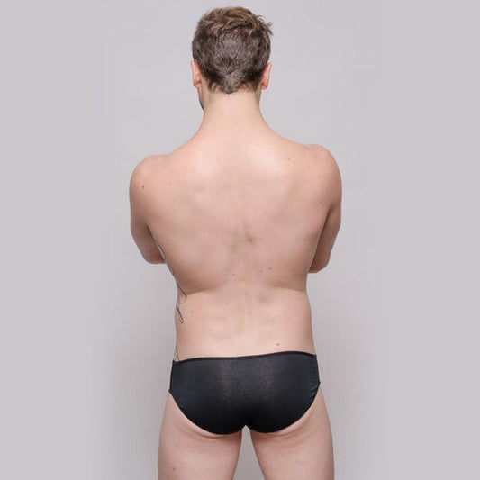 Black men's bikini underwear by Tartarus featuring a minimal three-string design shown from the back on a model.