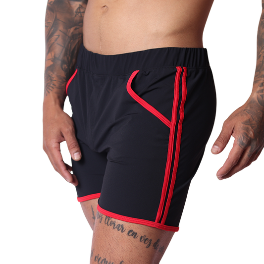 Gigo Typer black athletic shorts, side view. Smooth fabric with red contrast piping and trim detail on waist and legs.