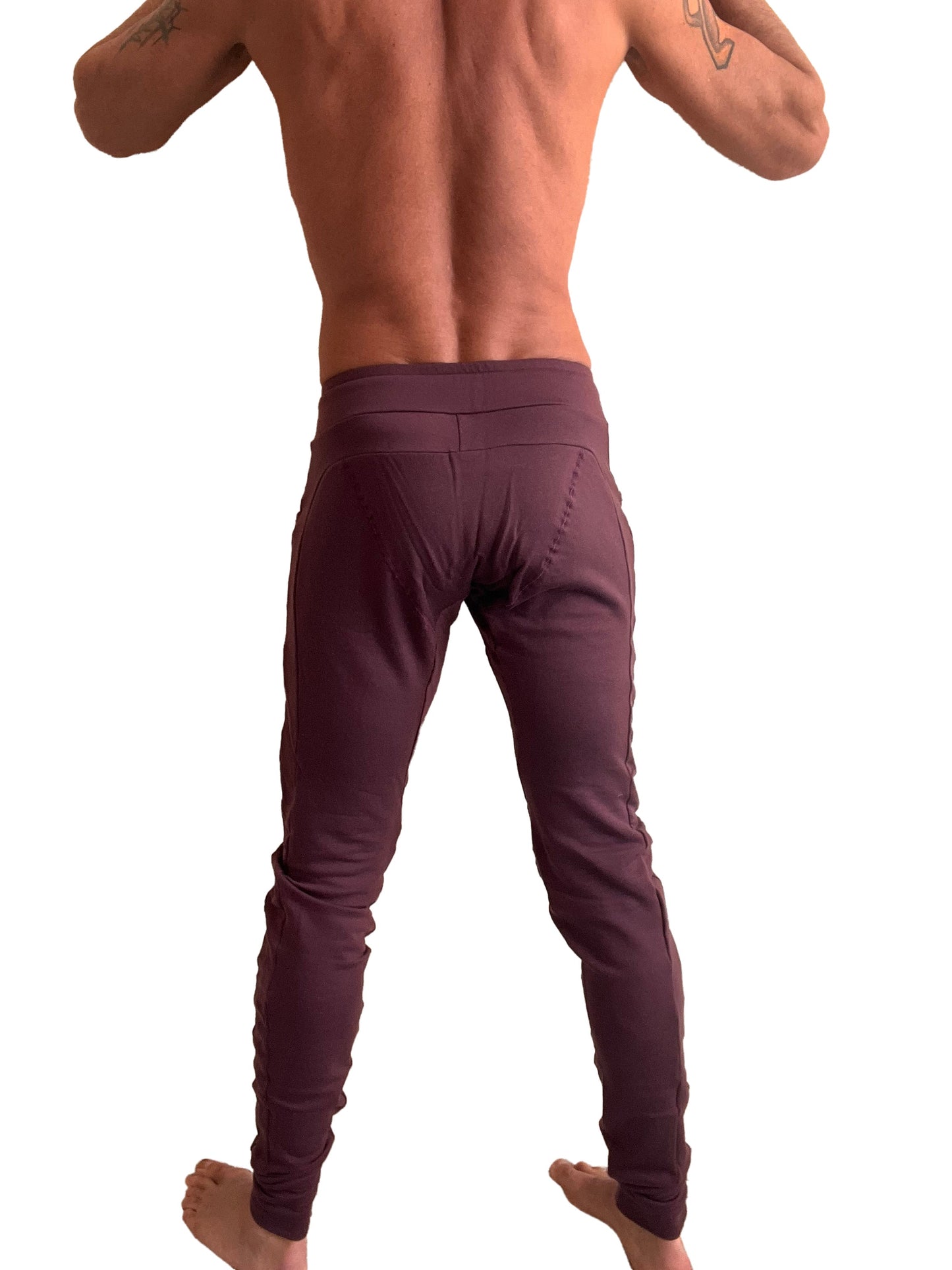 A pair of form-fitting deep burgundy winter edition luxury-fleece jogger and yoga sweat pants with high waistband and side seam detailing