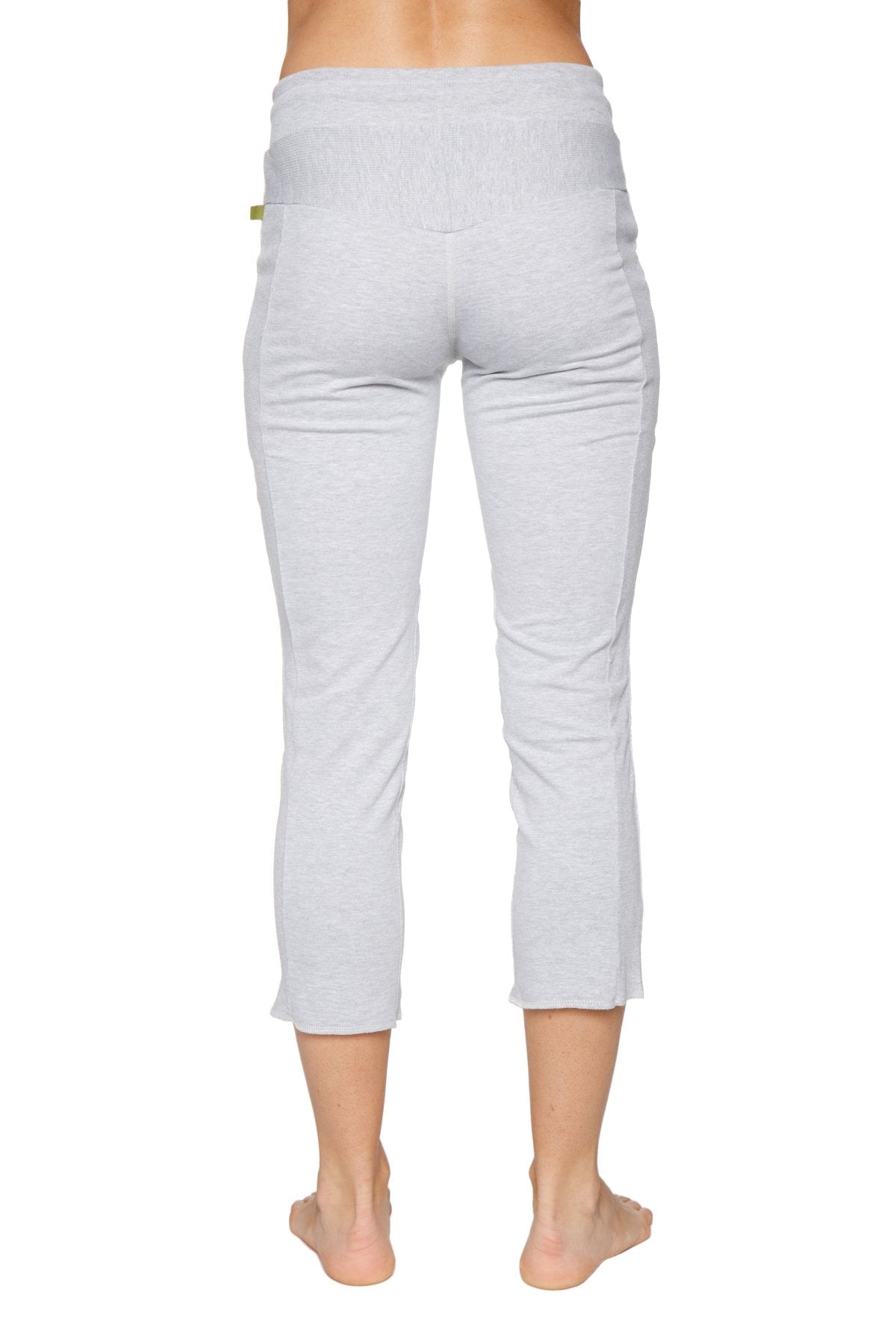 Back view of women’s heather grey 4/5 length zipper pocket capri yoga pants with soft texture and ribbed waistband