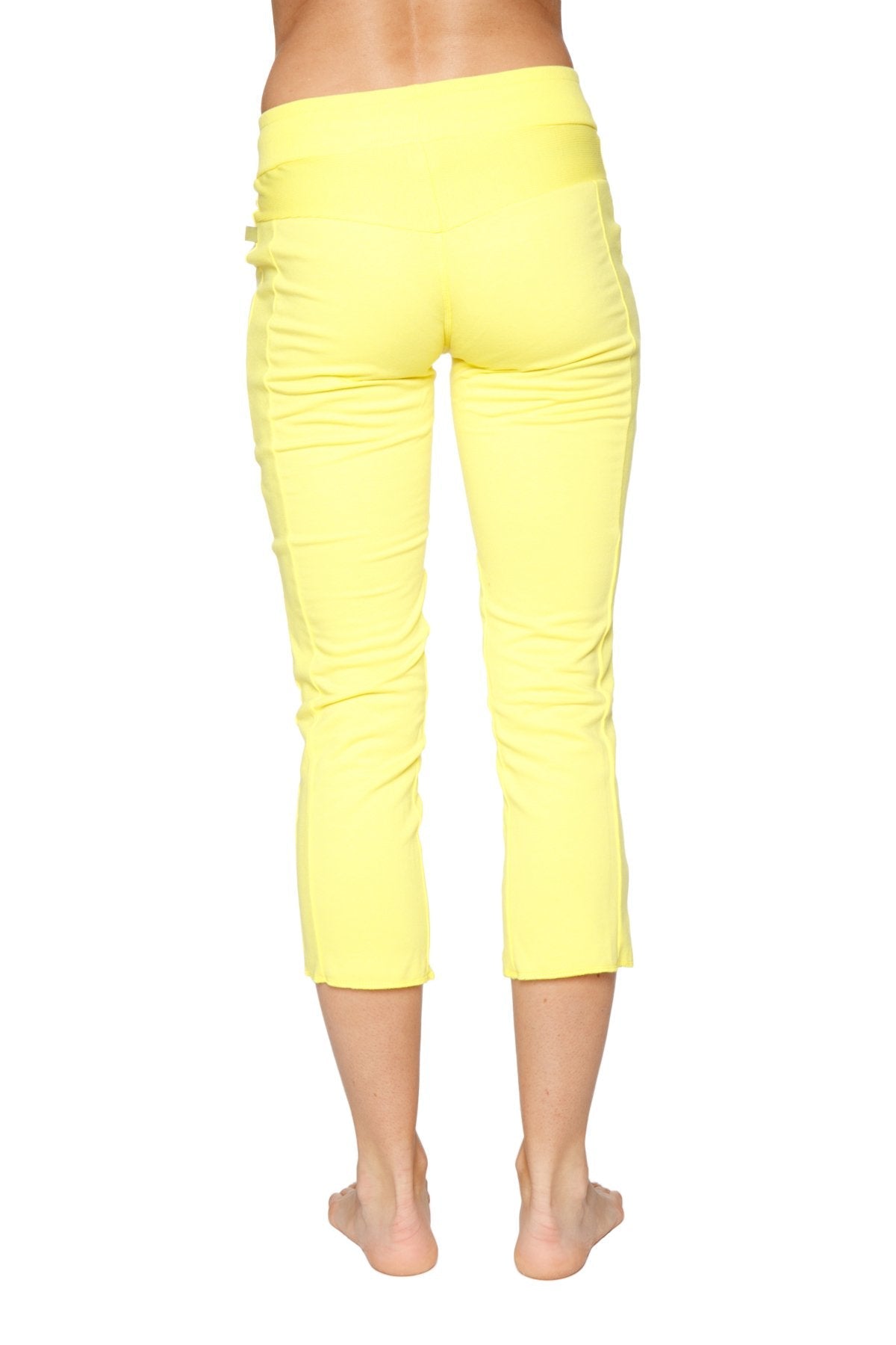 Women’s 4/5 length zipper pocket capri yoga pant in tropic yellow with smooth stretchy fabric and subtle side slits
