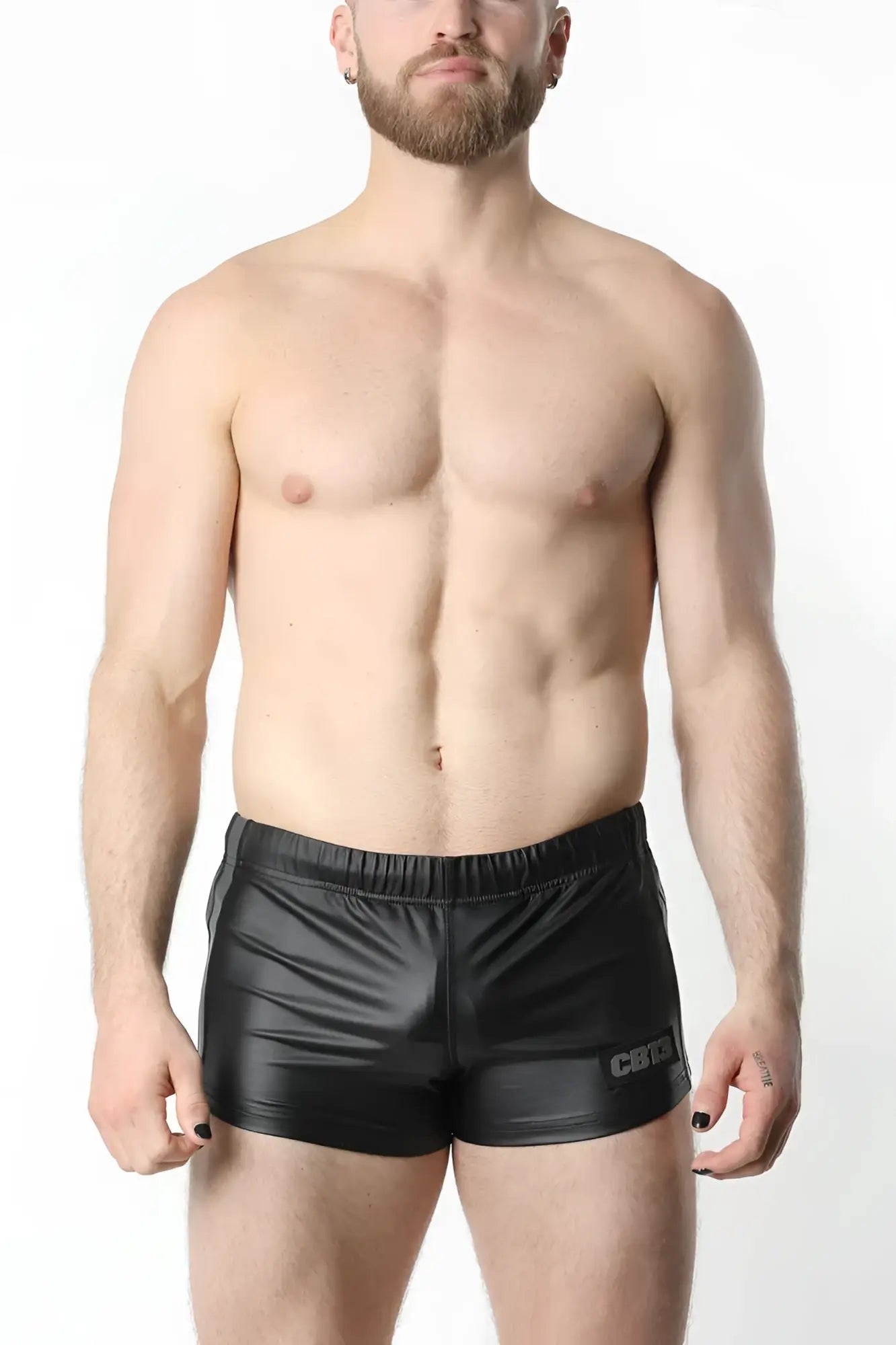 Black shiny faux leather anti-chrome gear short with subtle logo on the lower right leg front view