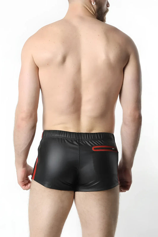 Black shiny faux leather anti-chrome gear shorts with red side stripes and back zipper pocket shown from the back