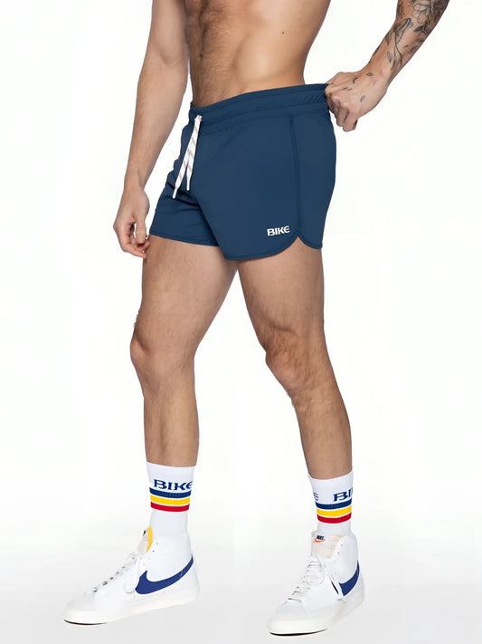 Navy blue bike track short with white drawstring and bike logo on the side made for athletic use