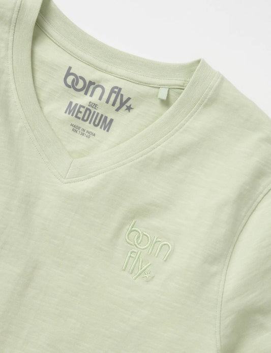 A light green cotton born fly v-neck tee with subtle embroidered logo on the chest and matching inside collar tag