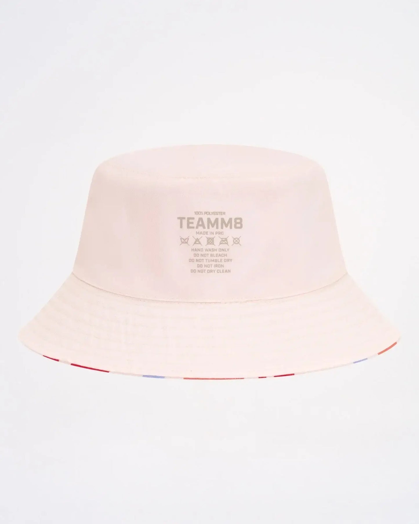 A soft blush pink cabana bucket hat featuring a subtle striped trim along the brim