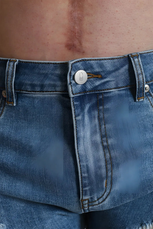 Blue denim cheeky summer 2.5 inch brief shorts with silver button and brown stitching in true blue color