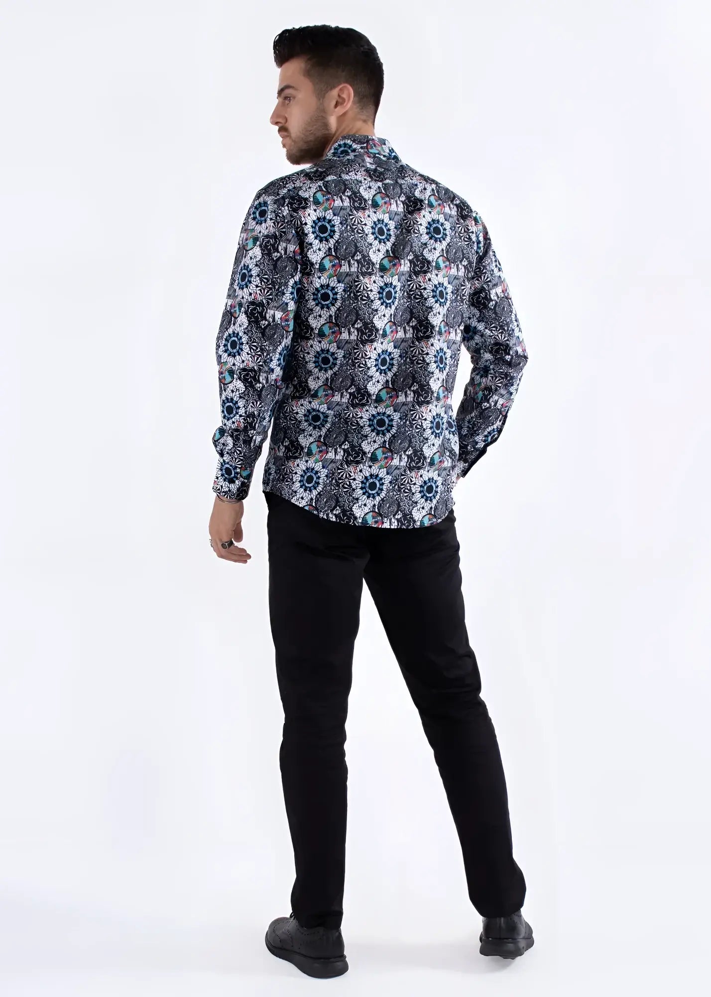 A man wearing a colored shapes print long-sleeved shirt with intricate navy white and muted blue geometric floral patterns