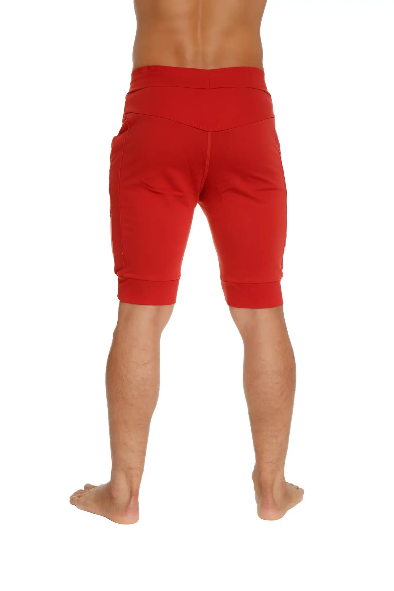 Cuffed yoga short in cinnabar red featuring high-waisted elastic band and ribbed cuffs for athletic wear