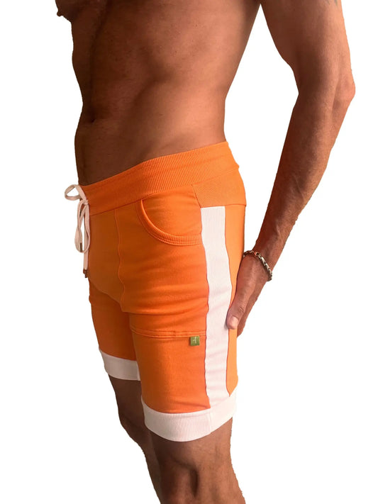 Orange cuffed yoga shorts with white vertical stripes ribbed cuffs and breathable fabric for athletic wear