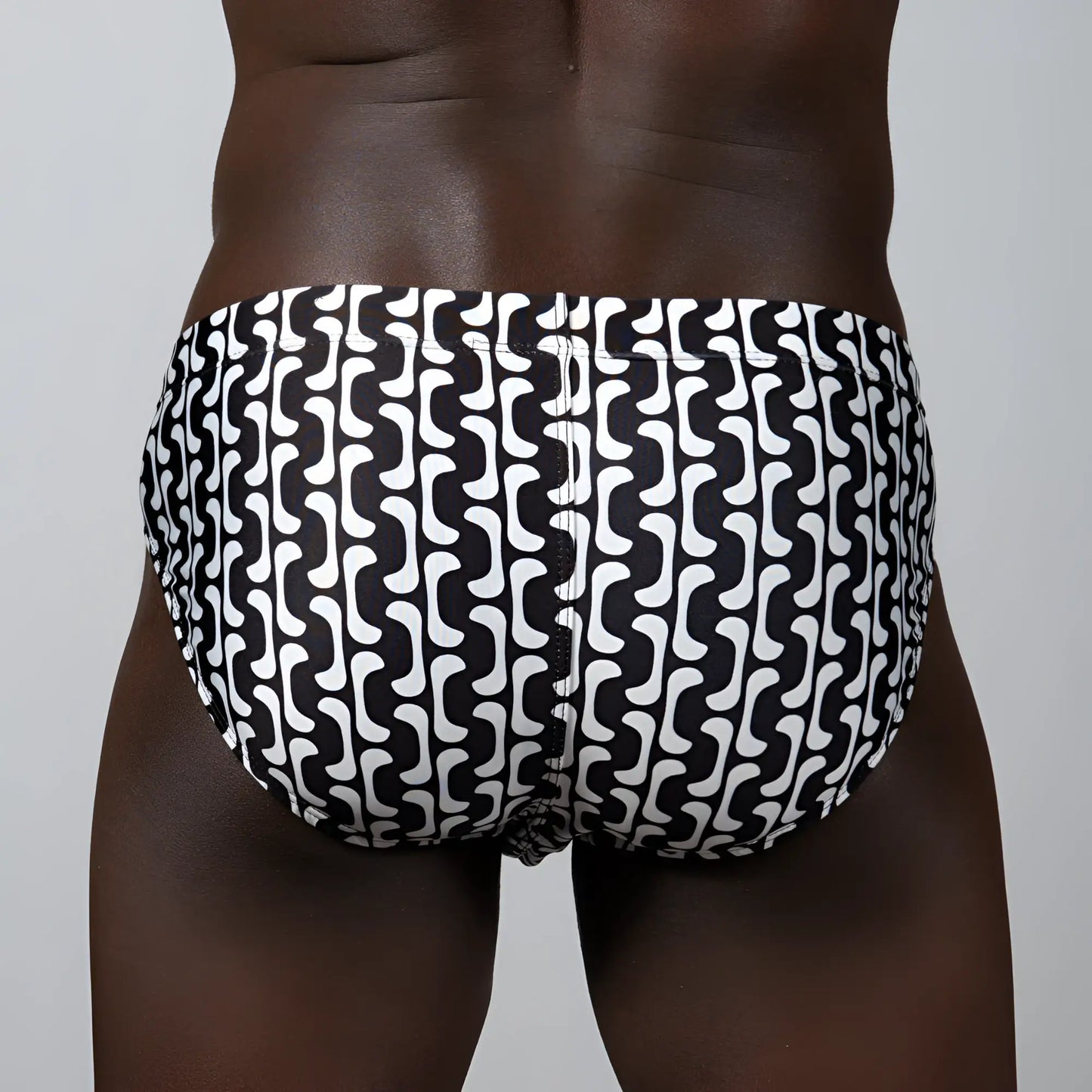 Black and white patterned swim trunks with a bold wavy geometric design in curves print brief style