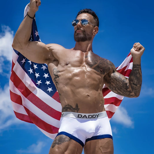 White briefs with blue trim and daddy branding on the waistband from the daddy ddg008 boxer trunk collection