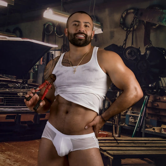 White ribbed tank top with slightly faded texture and visible wear worn over the torso with Daddy DDG019 boxer trunk