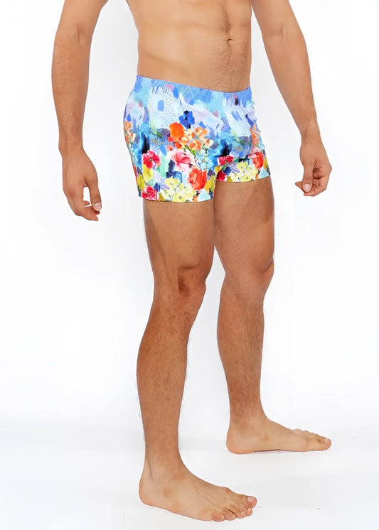Floral abstract printed swim shorts with vibrant floral pattern in red orange yellow and blue perfect for beachwear