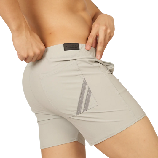 Beige gigo club gray athletic shorts back side with reflective diagonal stripes and black brand patch at waistband