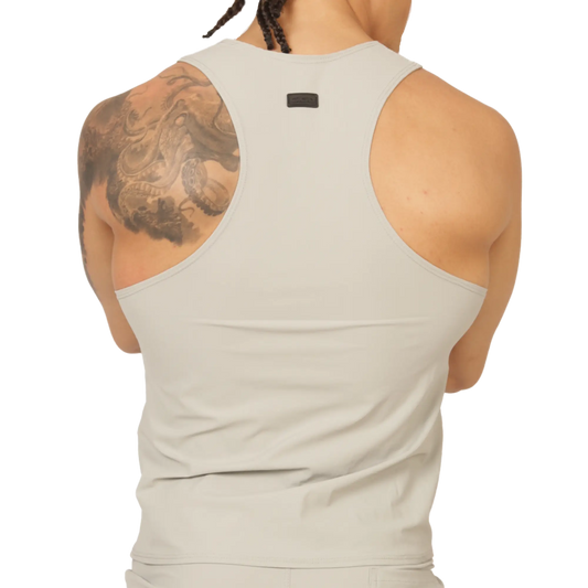 A sleek off-white racerback tank top with minimalist design and small black gigo club brand tag at the neckline