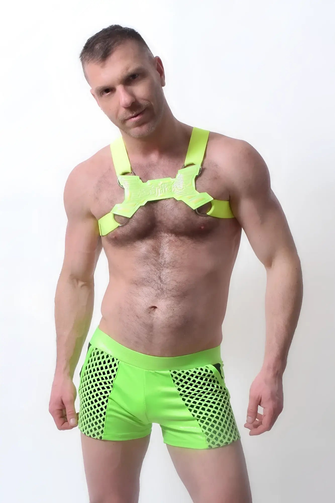 Bright neon green glowtime shorts mesh fabric paired with matching harness style top for bold activewear look