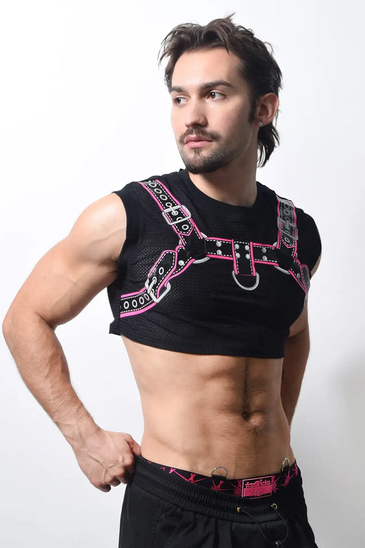 Harness crop top in black mesh with pink and silver leather-like straps and metal buckles and d-rings