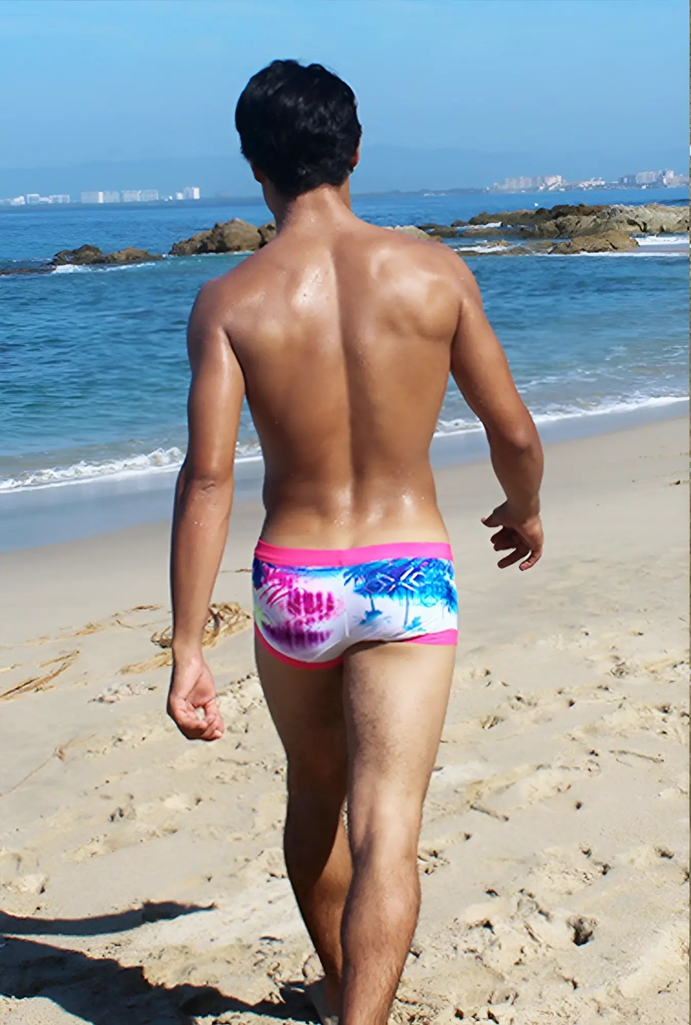Icker Sea Spring square cut trunk swimwear with a pink waistband and blue palm tree pattern on white background