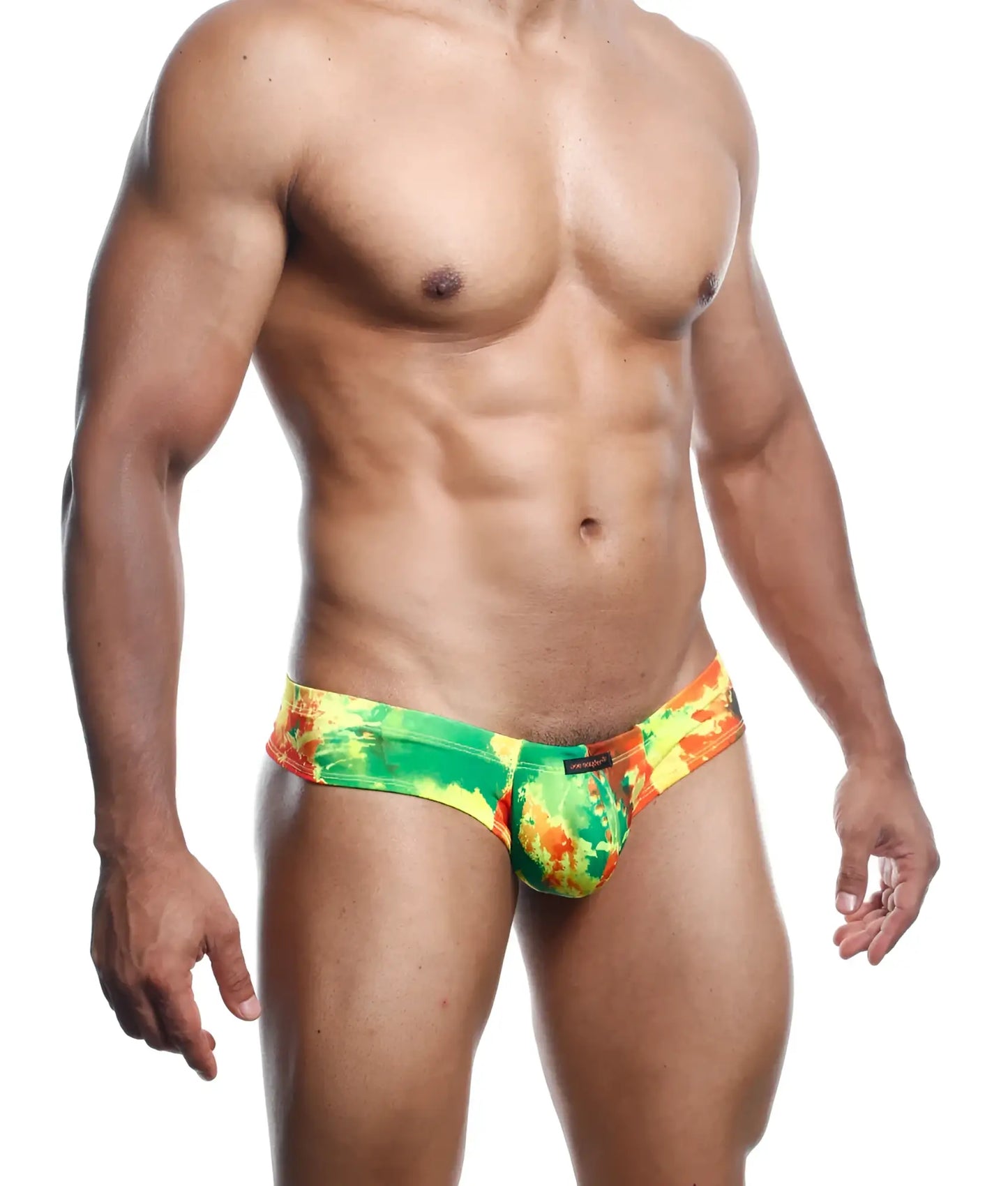 Vibrant green yellow and orange tie-dye joe snyder mini cheek swim trunks with a cheeky fit for swimming and beachwear