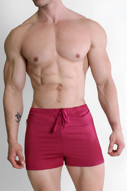 Bright red sleek fabric karma 2 inch short shorts with zipper pockets and drawstring waistband in magenta