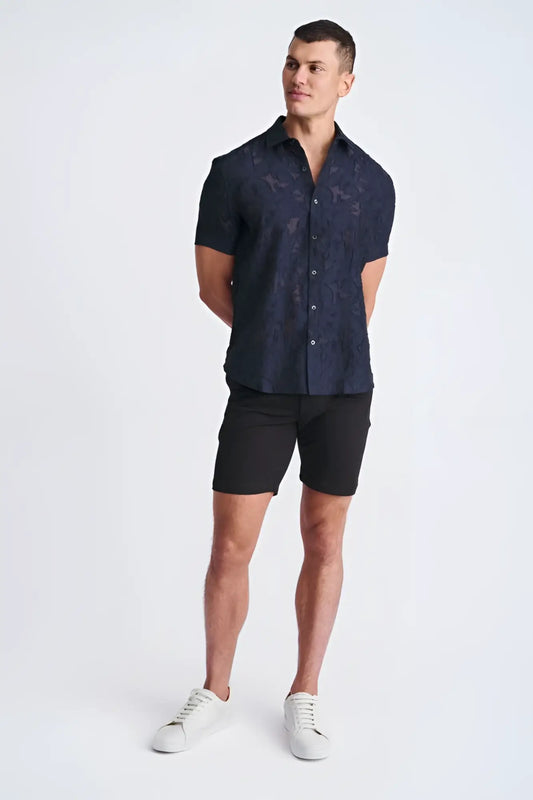 A navy blue lightweight jacquard short-sleeved button-up shirt with a subtle floral pattern