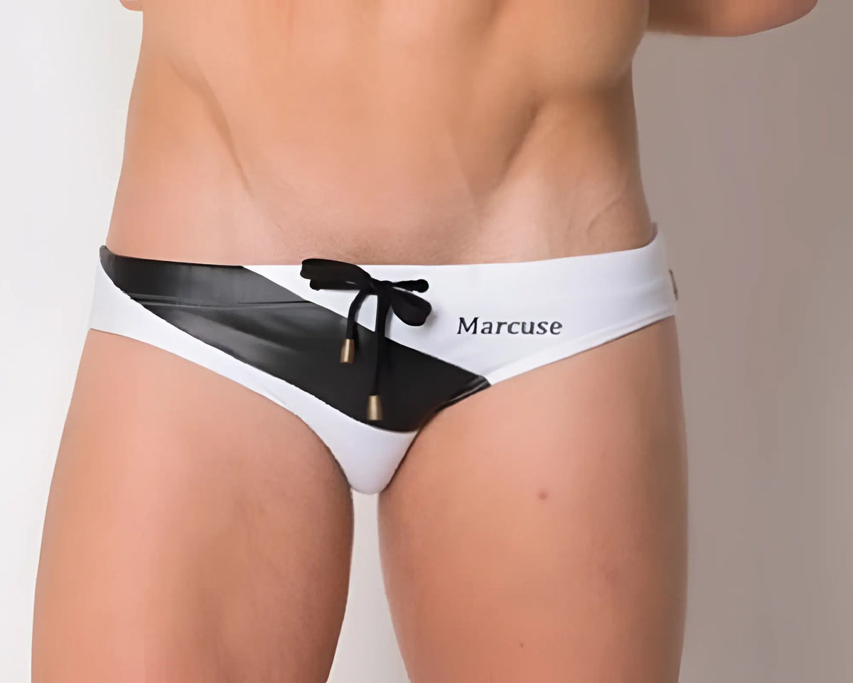 Marcuse MA_Xtreme swimwear white and black swim trunks with diagonal stripe drawstring closure and brand name on side