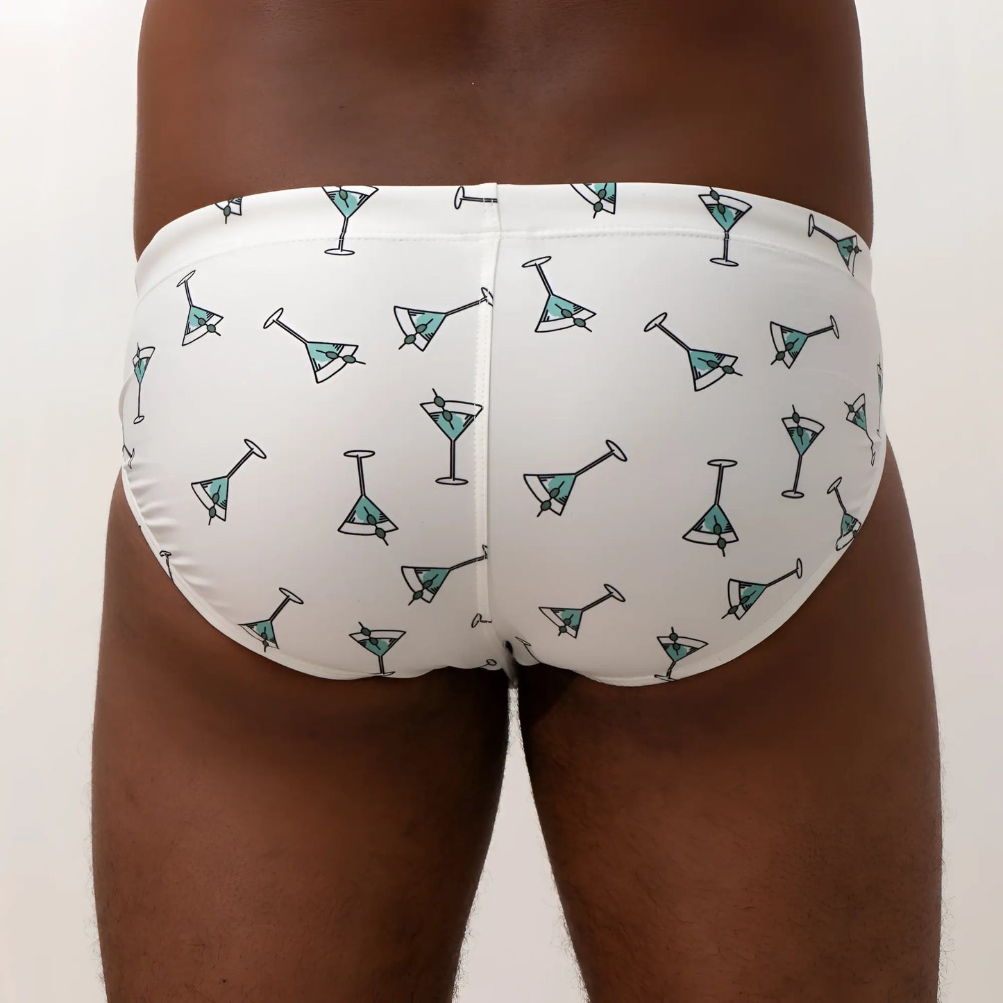 White martini swim brief featuring a playful teal martini glass pattern with black outlines for beachwear