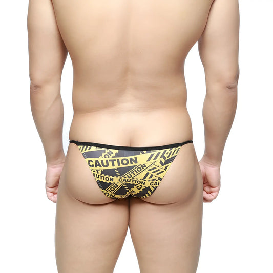 MetroMaleWear caution string bikini in black with yellow black caution tape pattern men’s briefs front view