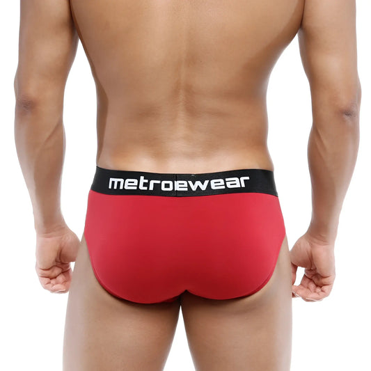 Red metrowear cotton hip briefs in terracotta with a black waistband featuring white lettering