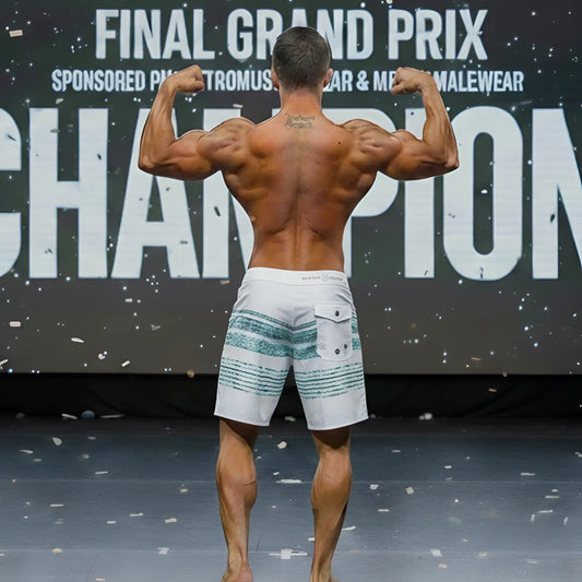 White board shorts with teal horizontal stripes and a back pocket from the MetroMaleWear Innocent Physique collection.