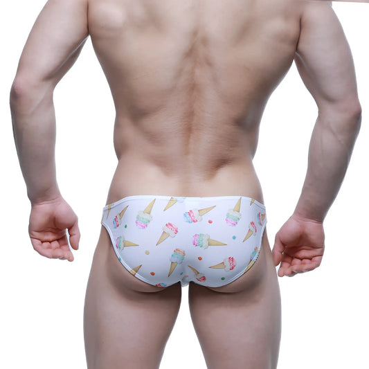 White swim trunks by metromalewear featuring a playful colorful ice cream cone and sprinkle pattern for summer wear