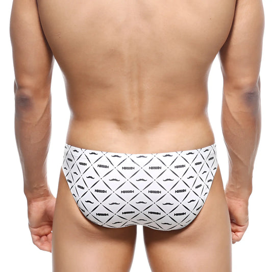 White metro malewear vasco hip brief swim trunks with black geometric mustache pattern and nassim text print