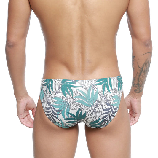 White swim trunks metro malewear meadow bikini 5103-56 with vibrant teal and dark gray tropical leaf pattern