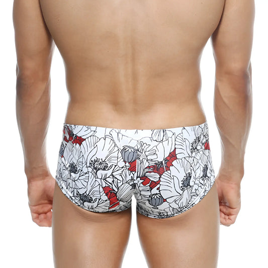 White swim trunks metro male wear oscar boxer escobar 2125-09 with bold floral pattern black outlines and red accents