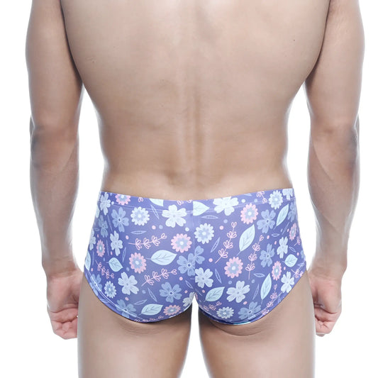 Purple floral swim trunks with light pink and white blossoms and green leaves on soft stretchy fabric by MetroMaleWear