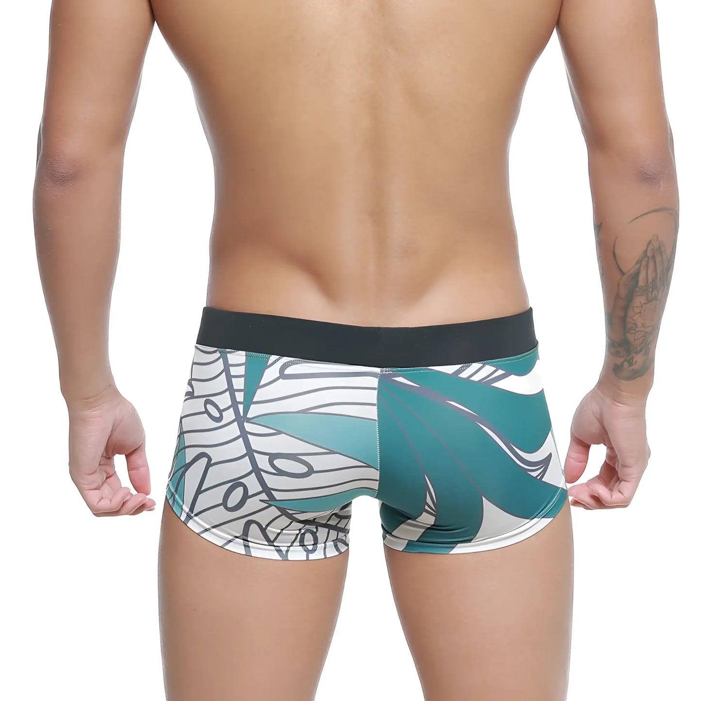 Teal and white tropical leaf patterned metro malewear profundo swim boxer briefs with black elastic waistband