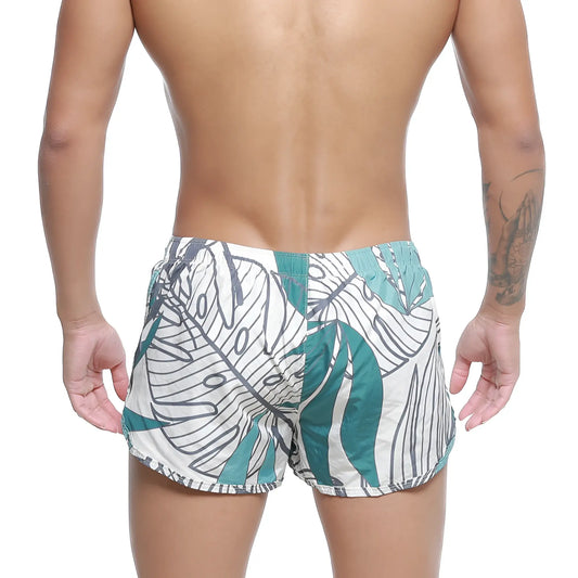 White swim trunks with bold teal and black tropical leaf pattern metroMalewear summer swim shorts meadow 4988-09