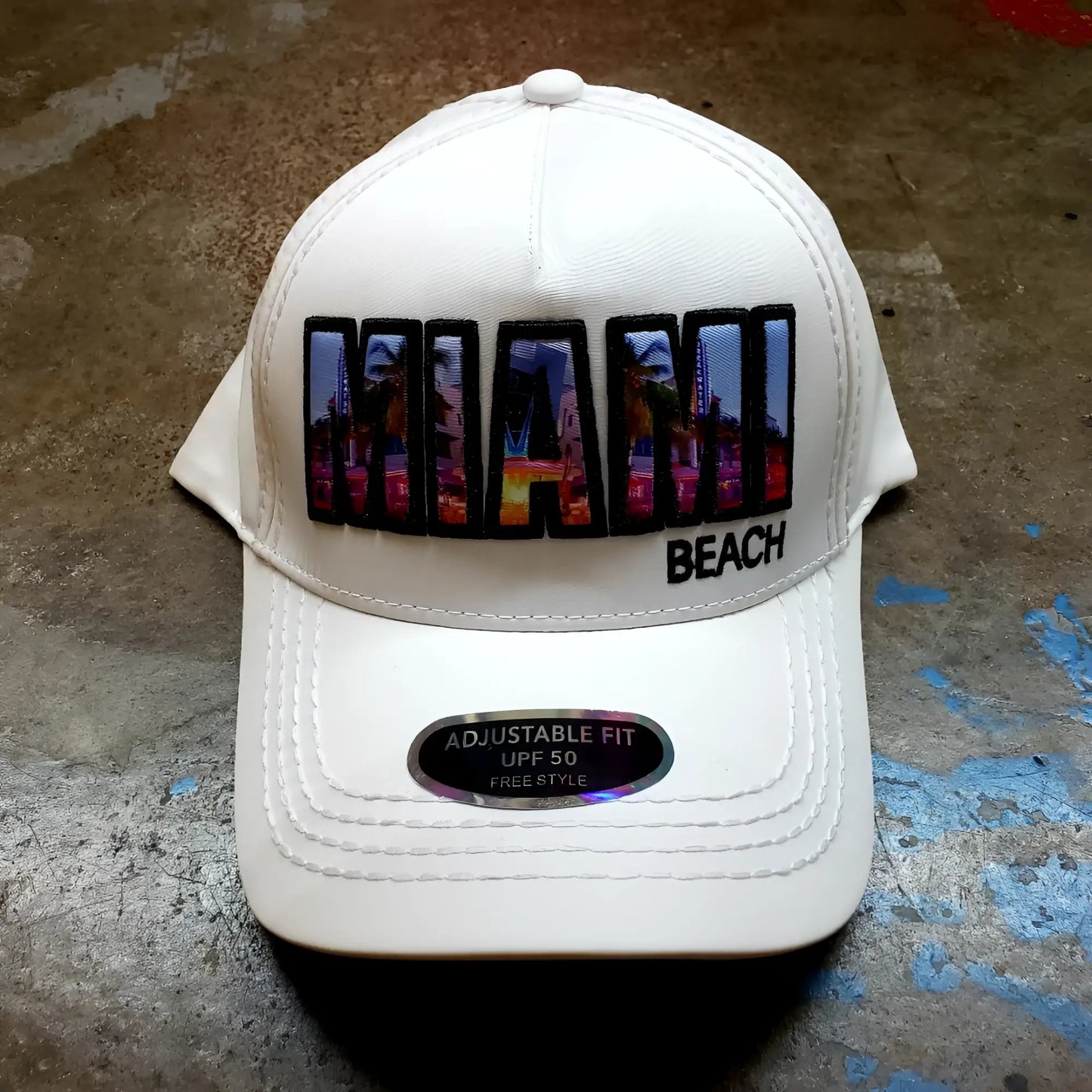 White baseball cap with vibrant colorful miami beach patch and urban skyline design with black trim