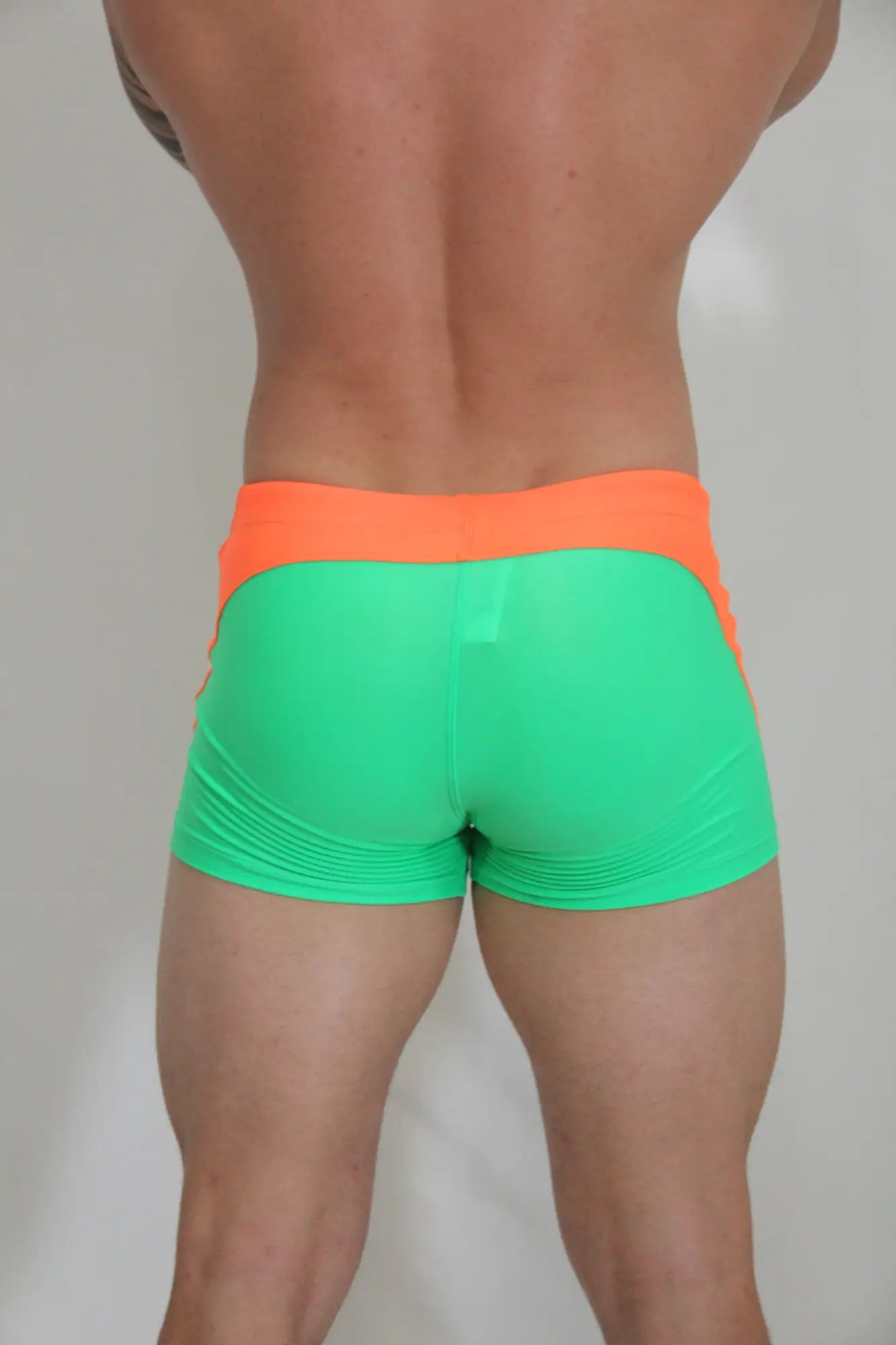 Neon curved sq cut trunk vibrant neon green and orange snug form-fitting athletic shorts for active wear