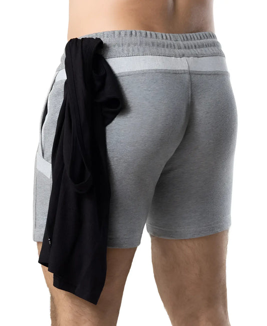 Back view of gray heathered nexus rugby short with ribbed waistband side pockets and black garment tied to back